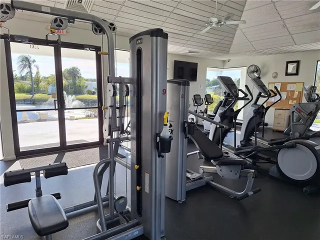 Workout area with a paneled ceiling and a ceiling fan