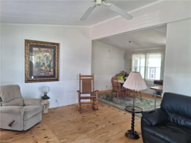 Living area featuring lofted ceiling and ceiling fan