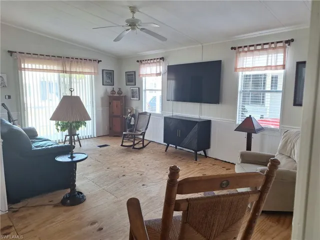 Living area with lofted ceiling and ceiling fan