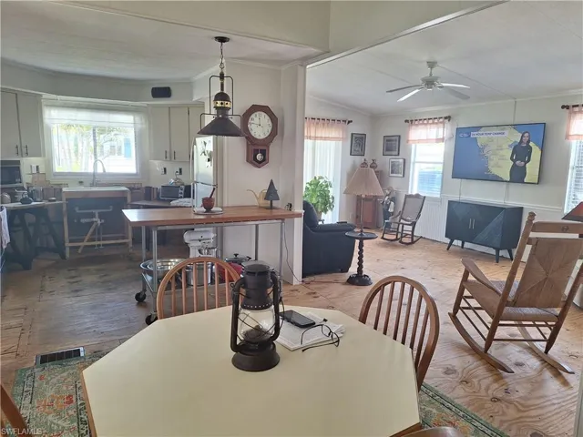 Dining area with ornamental molding and plenty of natural light