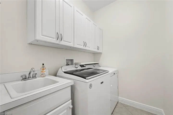 laundry with upper and lower cabinetry and sink