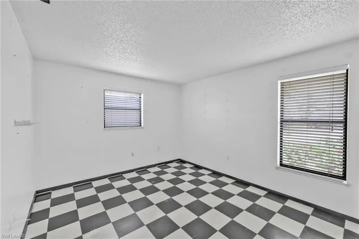 Spare room with tile patterned floors and a textured ceiling