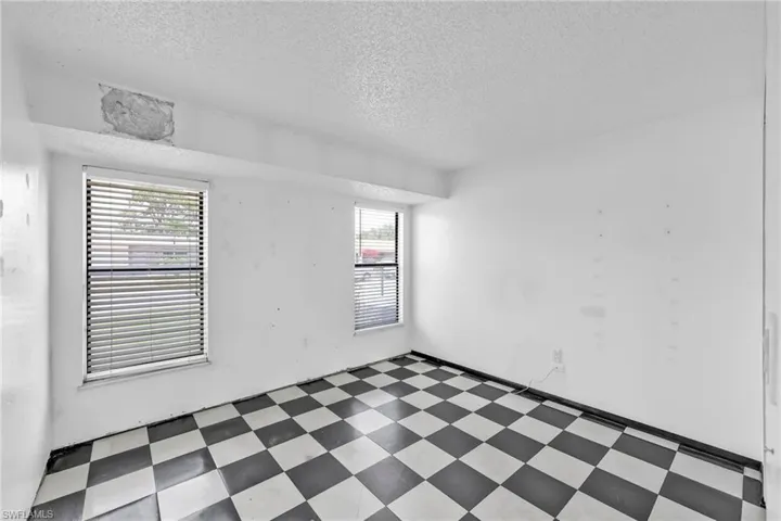 Unfurnished room with tile patterned floors and a textured ceiling