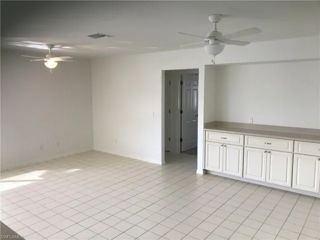 Unfurnished room featuring a ceiling fan and light tile patterned floors