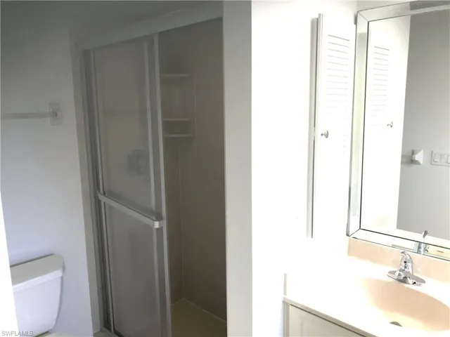 Full bathroom featuring vanity and a stall shower