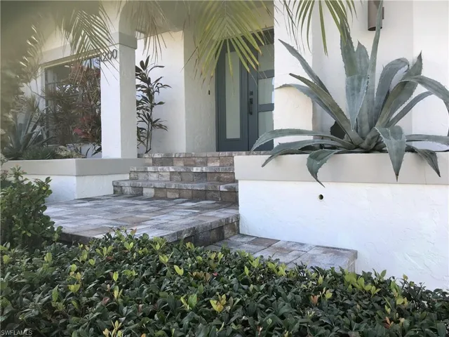 Property entrance with stucco siding and stone siding