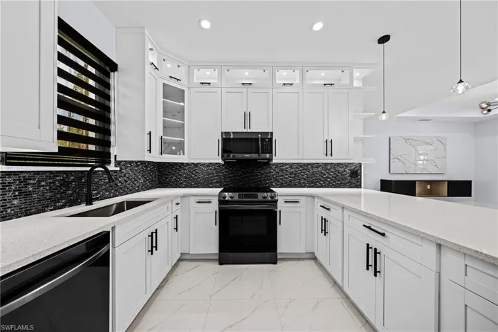 Kitchen with dishwasher, electric range, a sink, light marble finish floors, and open shelves