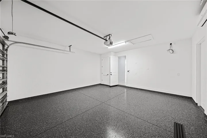 Garage with a garage door opener and a wall unit AC