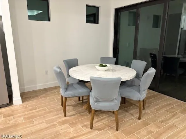 Dining room with wood tiled floors and baseboards