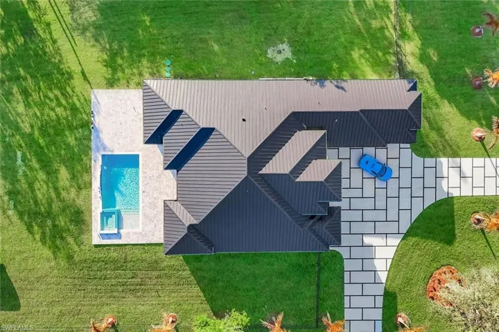 Aerial view of property and surrounding area featuring a pool