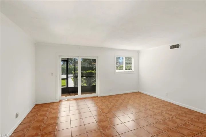Living room and hurricane high impact slider doors to the screened lanai