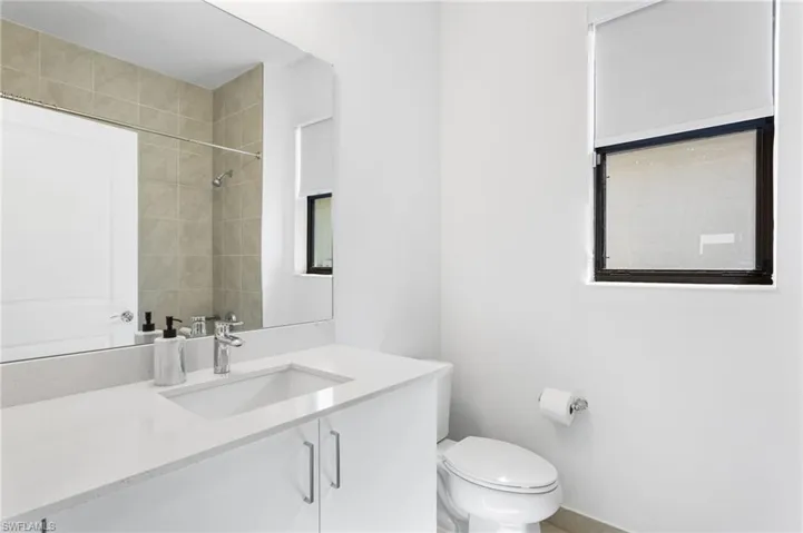 Bathroom featuring vanity and a shower
