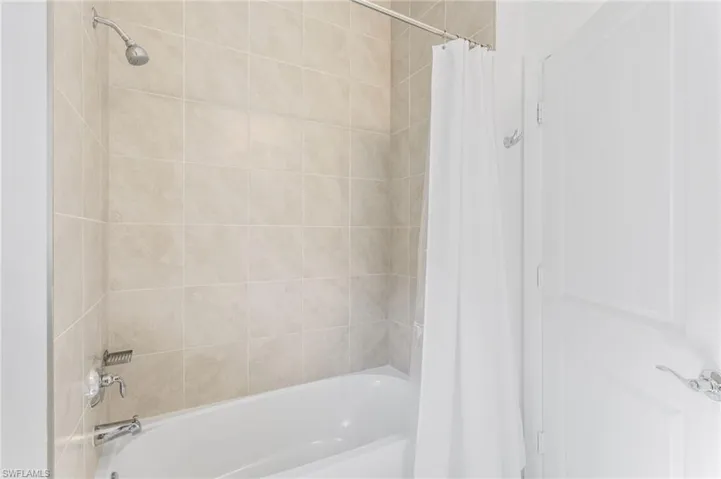 Bathroom featuring shower / bath combination with curtain