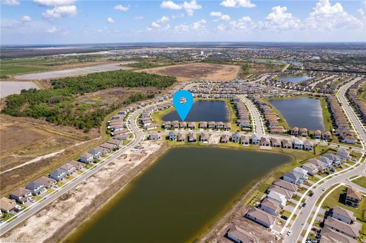 Aerial overview of property's location featuring nearby suburban area and a nearby body of water