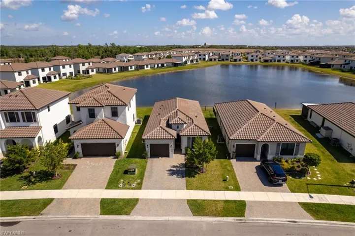 Aerial perspective of suburban area featuring a large body of water