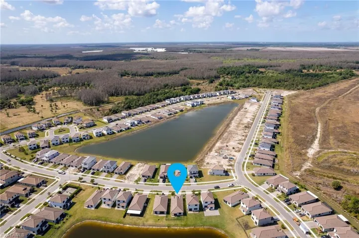 Aerial view of property's location with nearby suburban area and a large body of water
