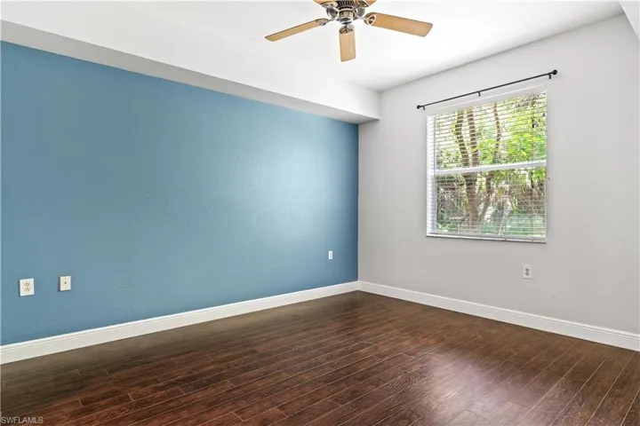 Empty room featuring hardwood / wood-style flooring and ceiling fan