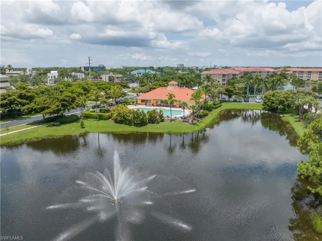 Drone / aerial view of Pool, clubhouse, and water feature