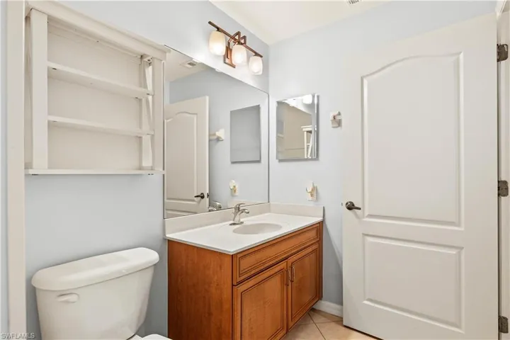 Bathroom featuring tile patterned flooring, shower/full bathtub combo, and vanity