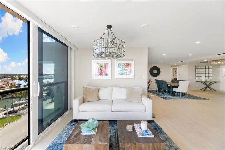 Living area featuring a chandelier, wood finished floors, plenty of natural light, and recessed lighting