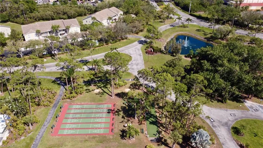 Birds eye view of property with a water view
