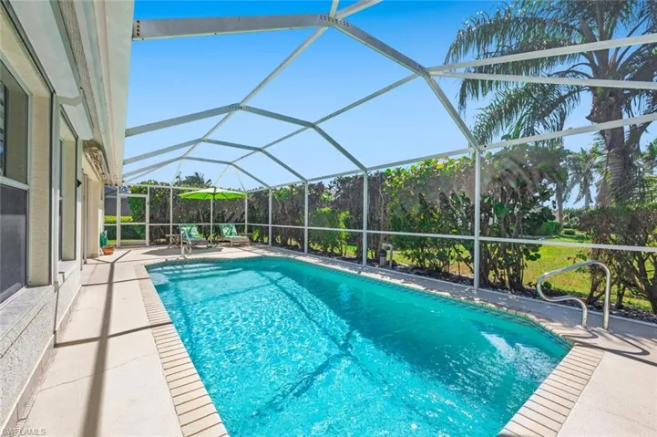 Outdoor pool with glass enclosure and a patio area