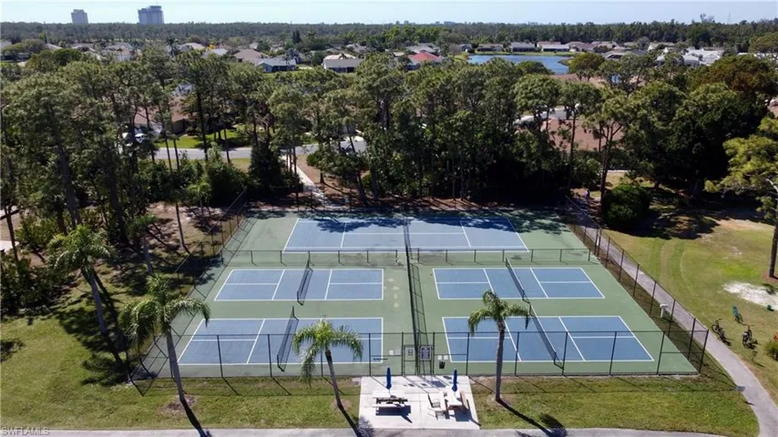 View of tennis court featuring fence
