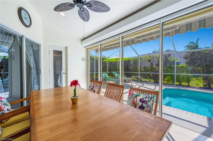 Sunroom / solarium featuring a ceiling fan and vaulted ceiling