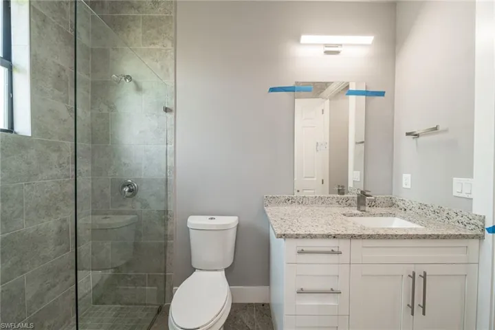 Full bathroom with vanity and a tile shower