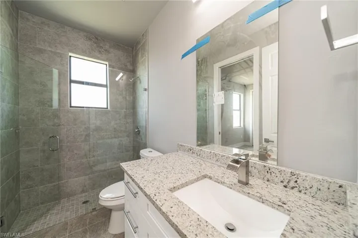 Full bathroom featuring vanity and a shower stall