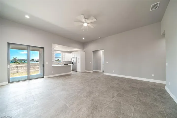 Unfurnished living room with ceiling fan and recessed lighting
