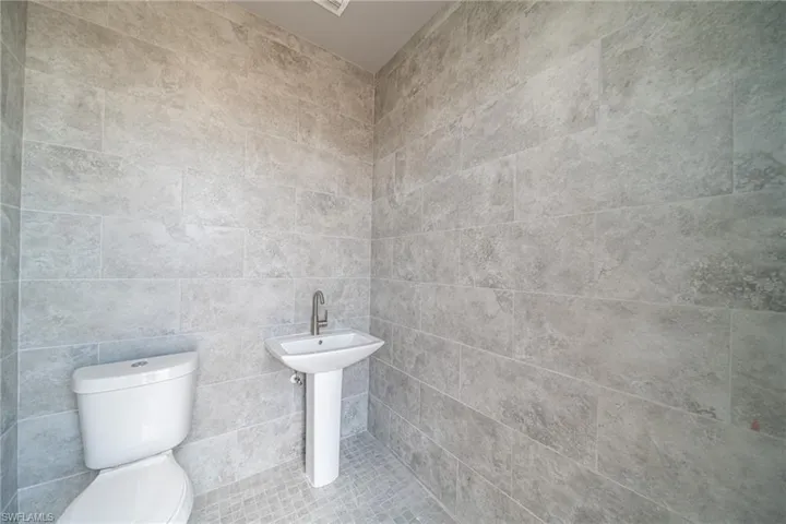 Half bath featuring toilet