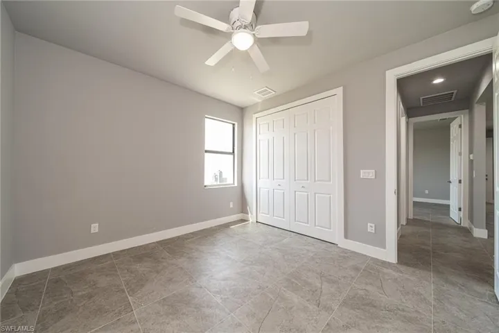 Unfurnished bedroom with a closet and a ceiling fan
