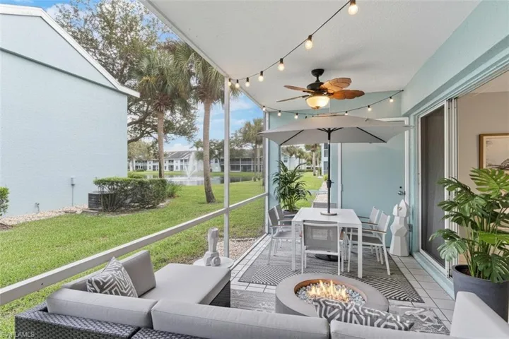 Screened patio virtual staged  featuring outdoor lounge area, ceiling fan, and a fire pit