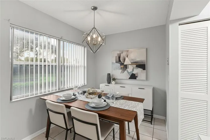 Dining space virtual staged featuring suspended lighting and baseboards