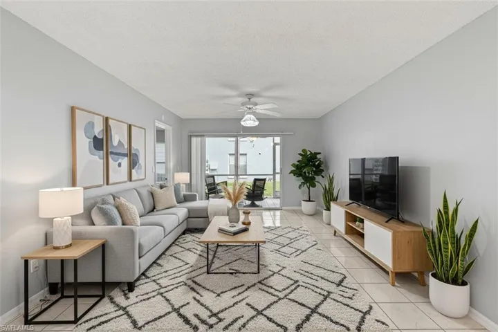 Living room virtual staged with a textured ceiling and a ceiling fan