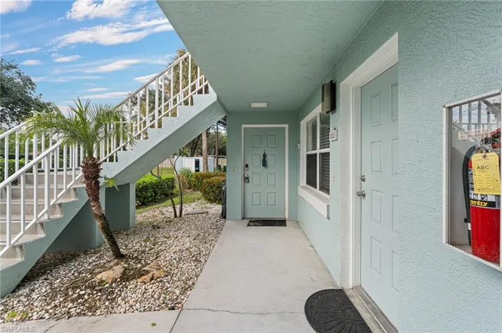 Entrance to property featuring stucco siding