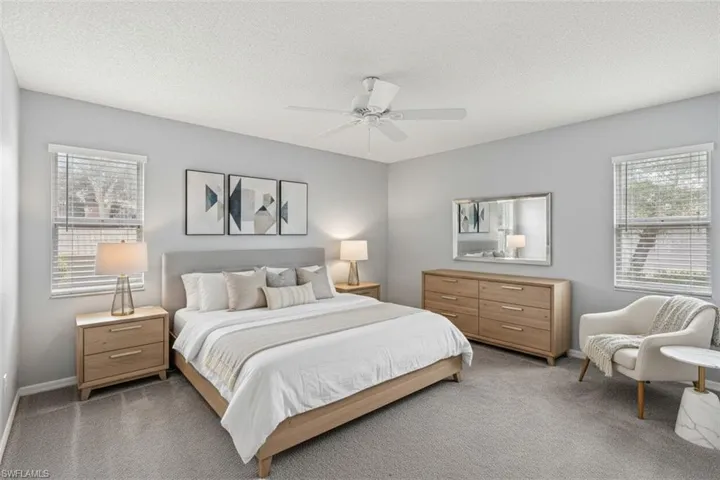 Master Bedroom virtual staged with carpet floors, a ceiling fan, and a textured ceiling