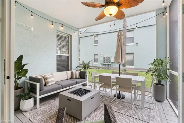 Screened patio virtual staged with a ceiling fan, an outdoor living / dining area, an outdoor fire pit, and a patio