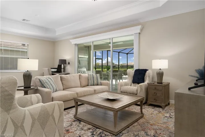 Living room with a raised ceiling and crown molding