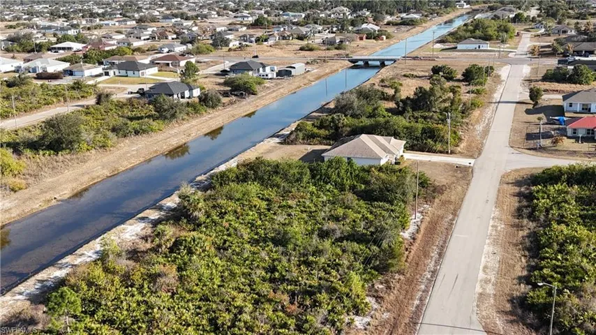 Aerial overview of property's location featuring nearby suburban area and a large body of water