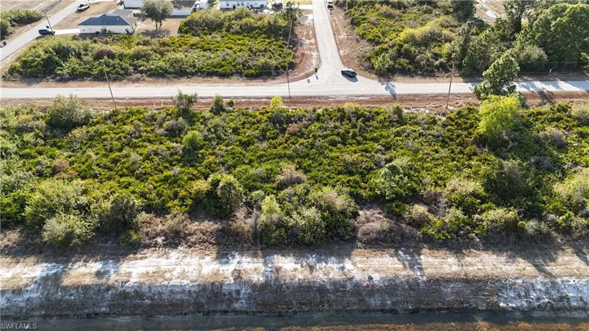 Aerial overview of property's location with a tree filled landscape