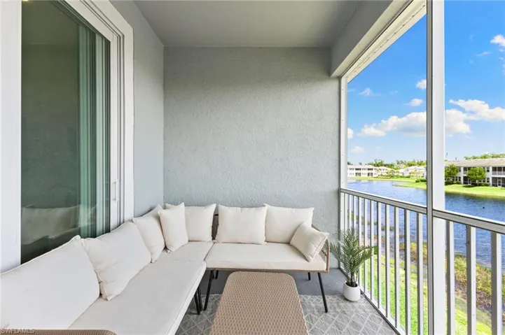 Balcony with a sunroom, a water view, and outdoor lounge area