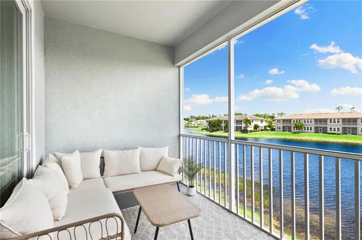 Balcony featuring a sunroom and a water view