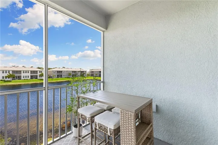 Balcony with a water view and a sunroom