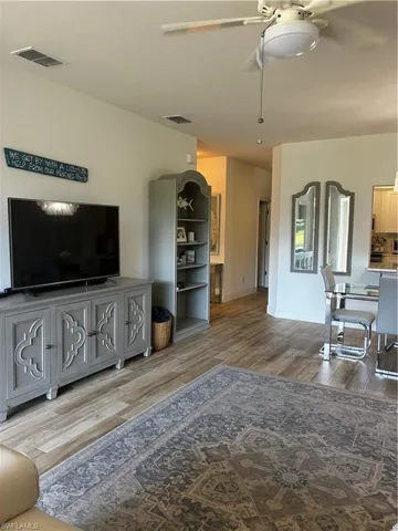 Living area featuring ceiling fan and wood finished floors
