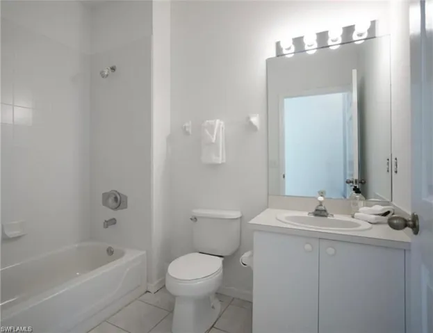 Guest Bathroom with vanity, shower / washtub combination, and light tile patterned flooring
