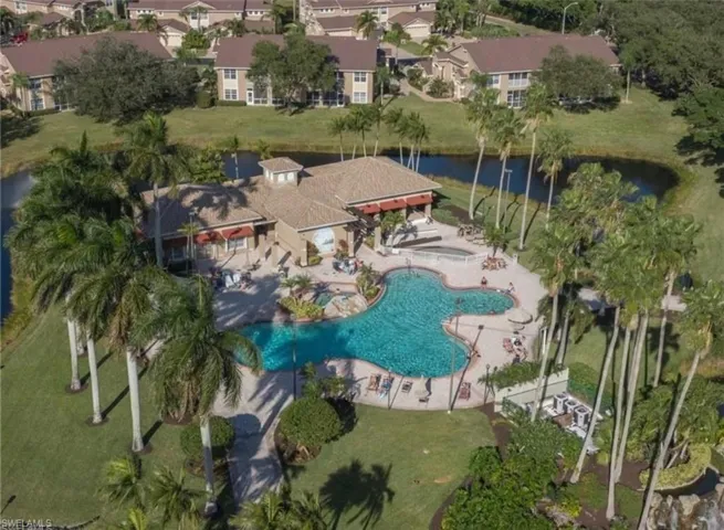 Aerial view of clubhouse area featuring a resort style pool area, spa and kiddie pool plus fitness room.