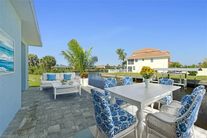 View of patio / terrace featuring an outdoor hangout area and a water view(Staged Photo)