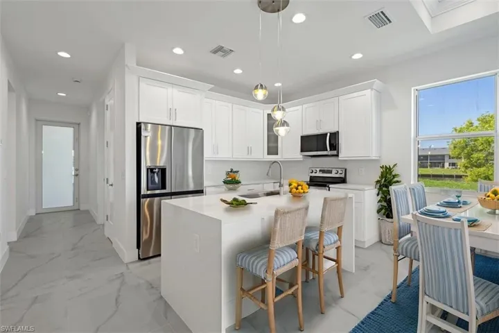 Kitchen featuring visible vents, recessed lighting, appliances with stainless steel finishes, and a sink (Staged Photo)